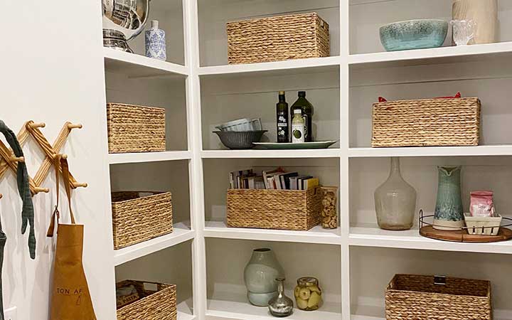 hygge pantry organized using different textures such baskets and wire containters 